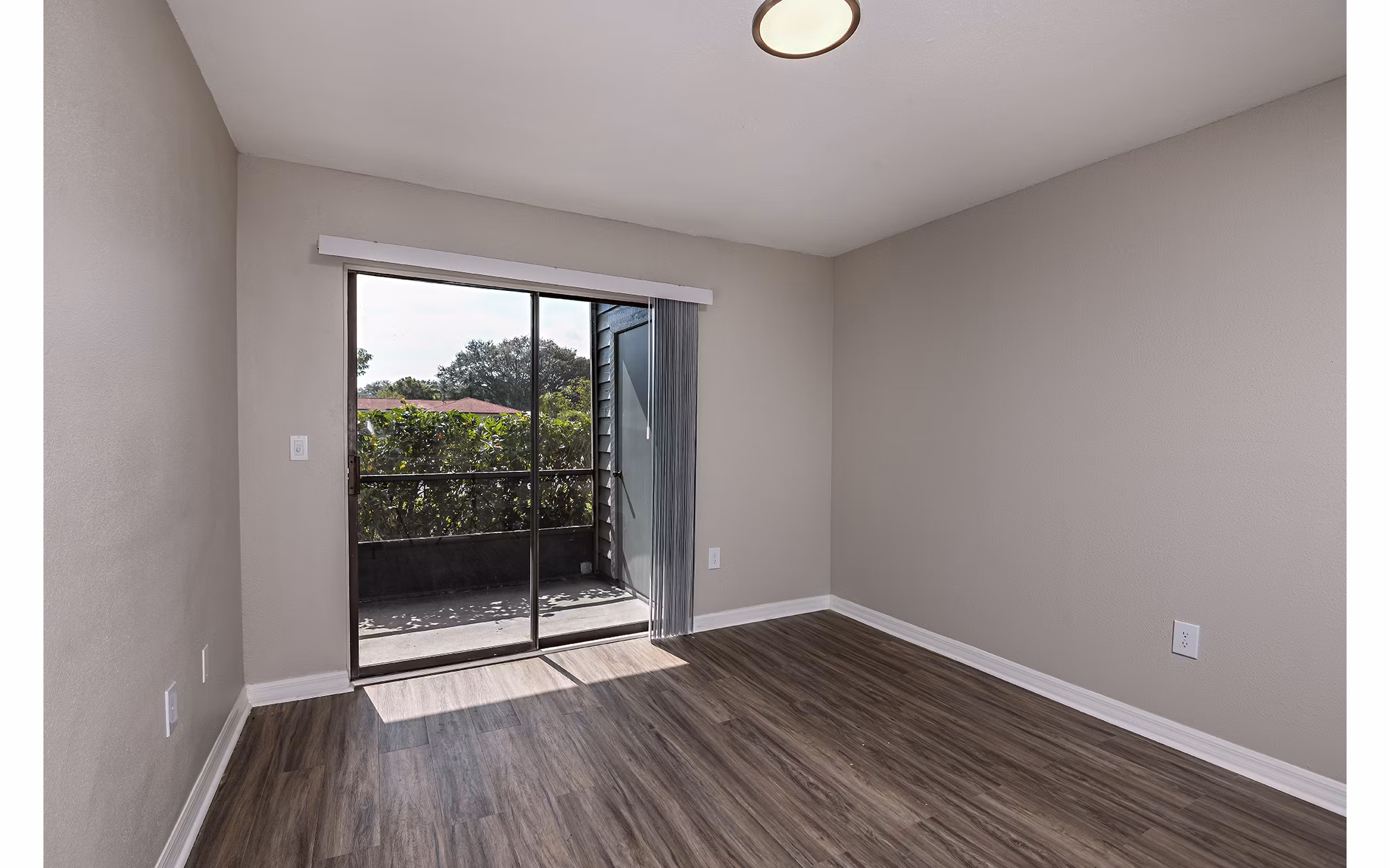 Spacious living room with modern decor and large windows in Lake Pointe Apartments