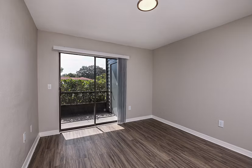 Spacious living room with modern decor and large windows in Lake Pointe Apartments
