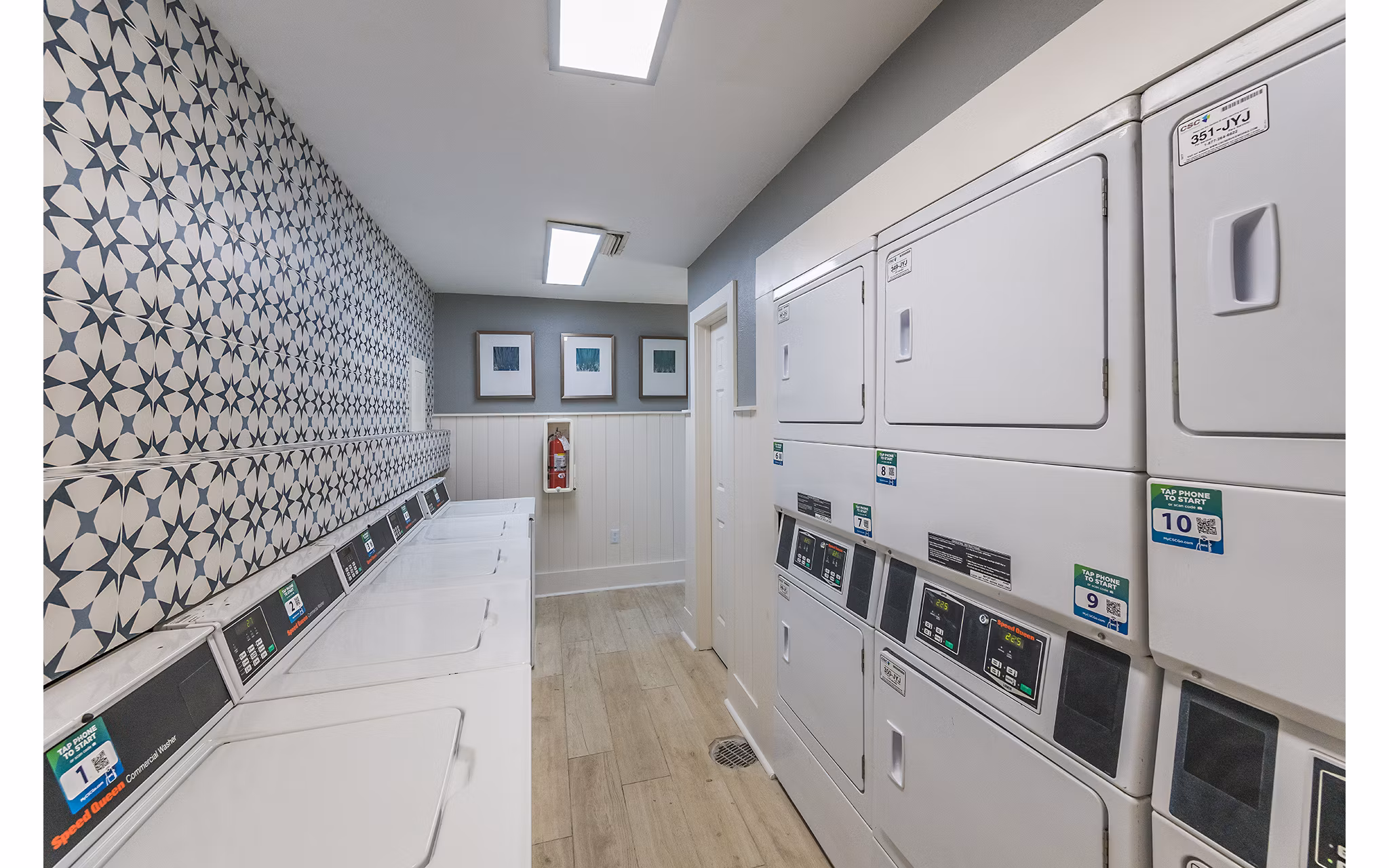 Laundry area featuring modern washers and dryers at Lake Pointe Apartments, luxury living with convenient amenities