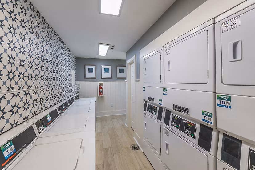 Laundry area featuring modern washers and dryers at Lake Pointe Apartments, luxury living with convenient amenities