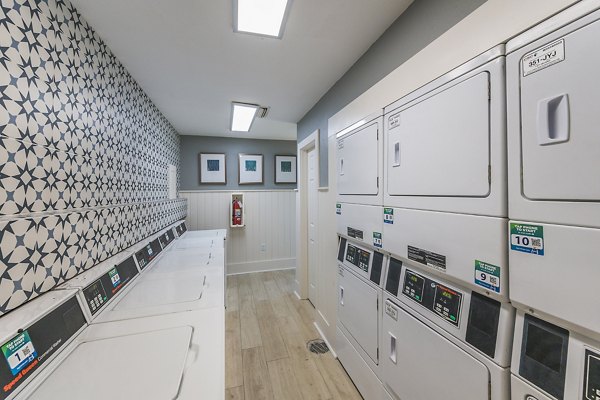 Laundry area featuring modern washers and dryers at Lake Pointe Apartments, luxury living with convenient amenities