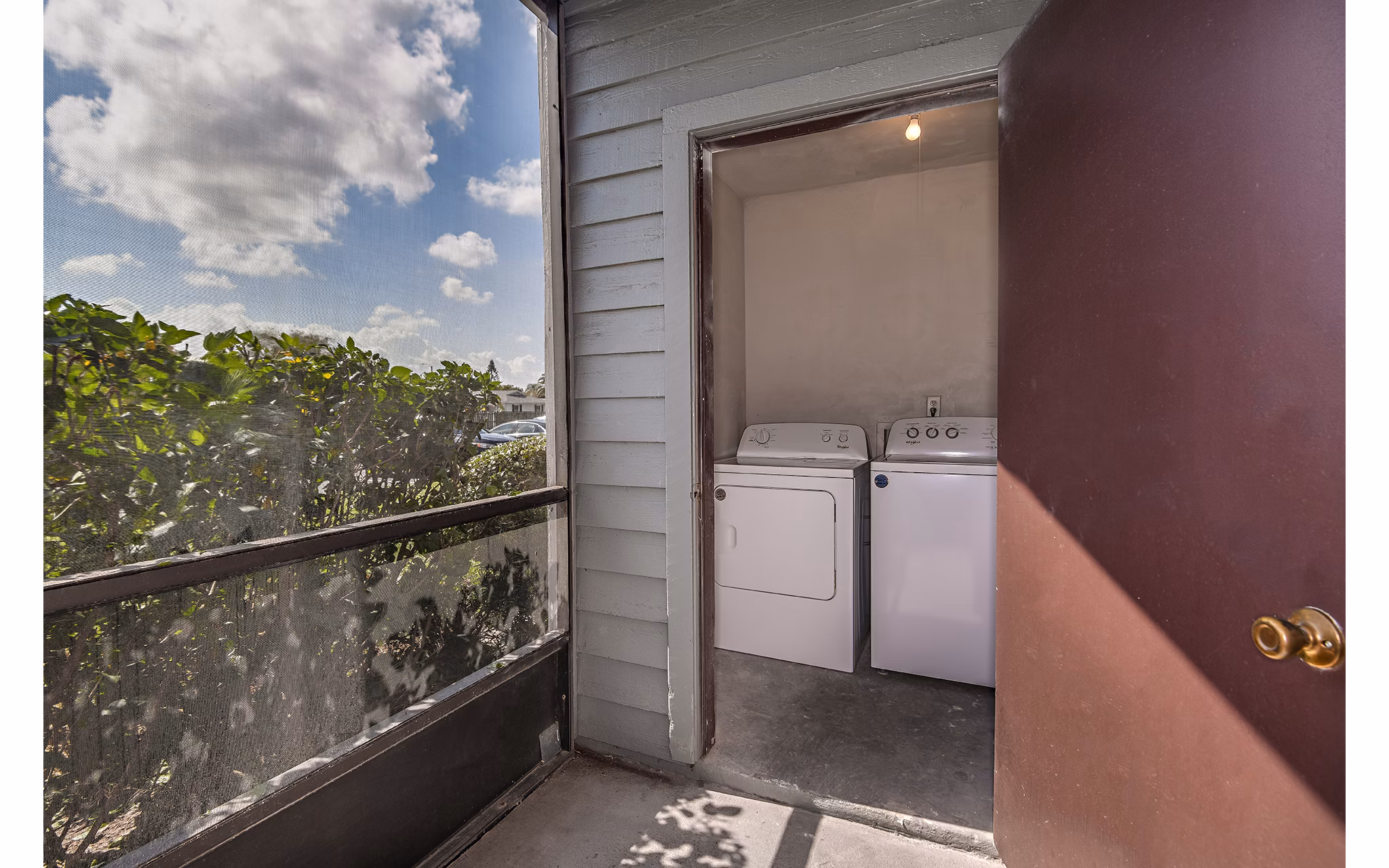 Patio with comfortable seating at Lake Pointe Apartments in a serene lakeside setting