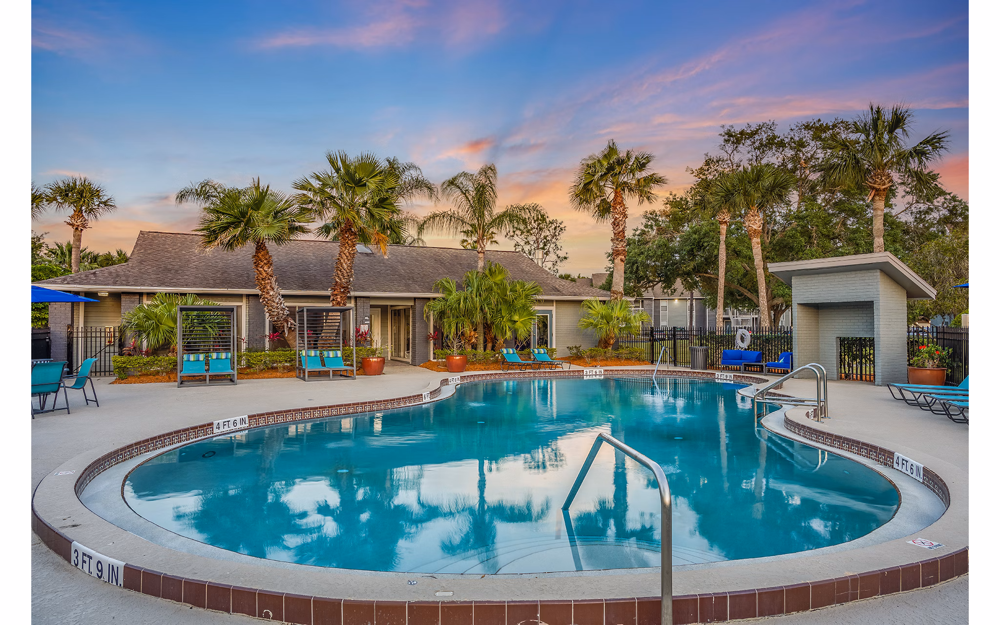 Resort-style pool with lounge chairs at Lake Pointe Apartments, providing a luxurious outdoor experience for residents