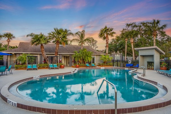 Resort-style pool with lounge chairs at Lake Pointe Apartments, providing a luxurious outdoor experience for residents