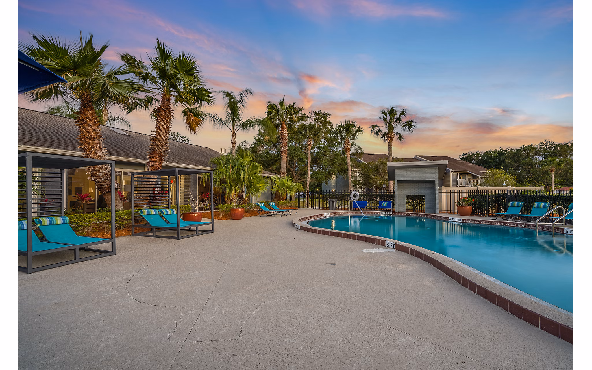 Infinity pool with lounge seating at Lake Pointe Apartments