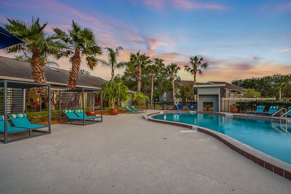 Infinity pool with lounge seating at Lake Pointe Apartments