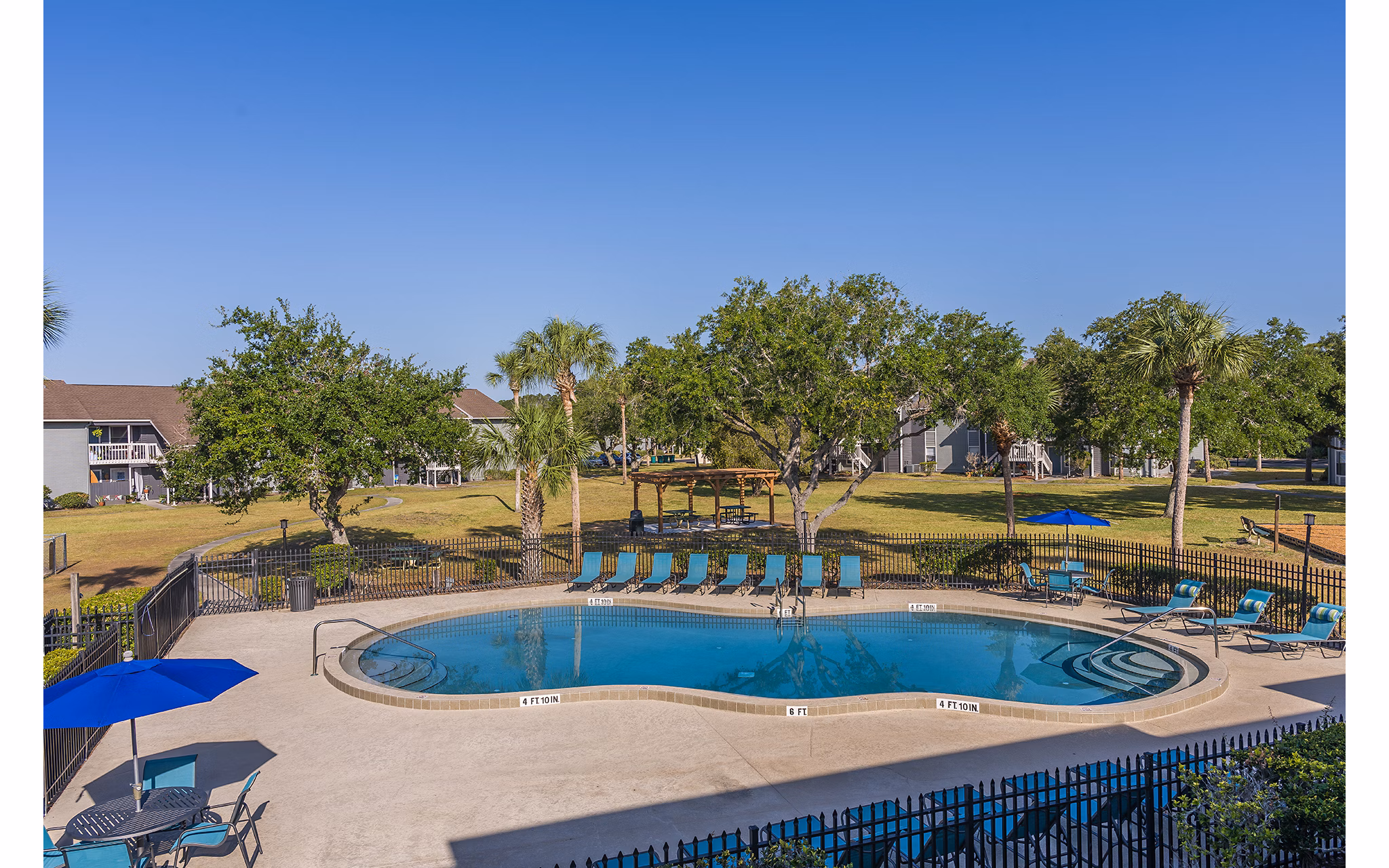Sparkling pool with sun loungers at Lake Pointe Apartments offers relaxing outdoor space in this luxury community