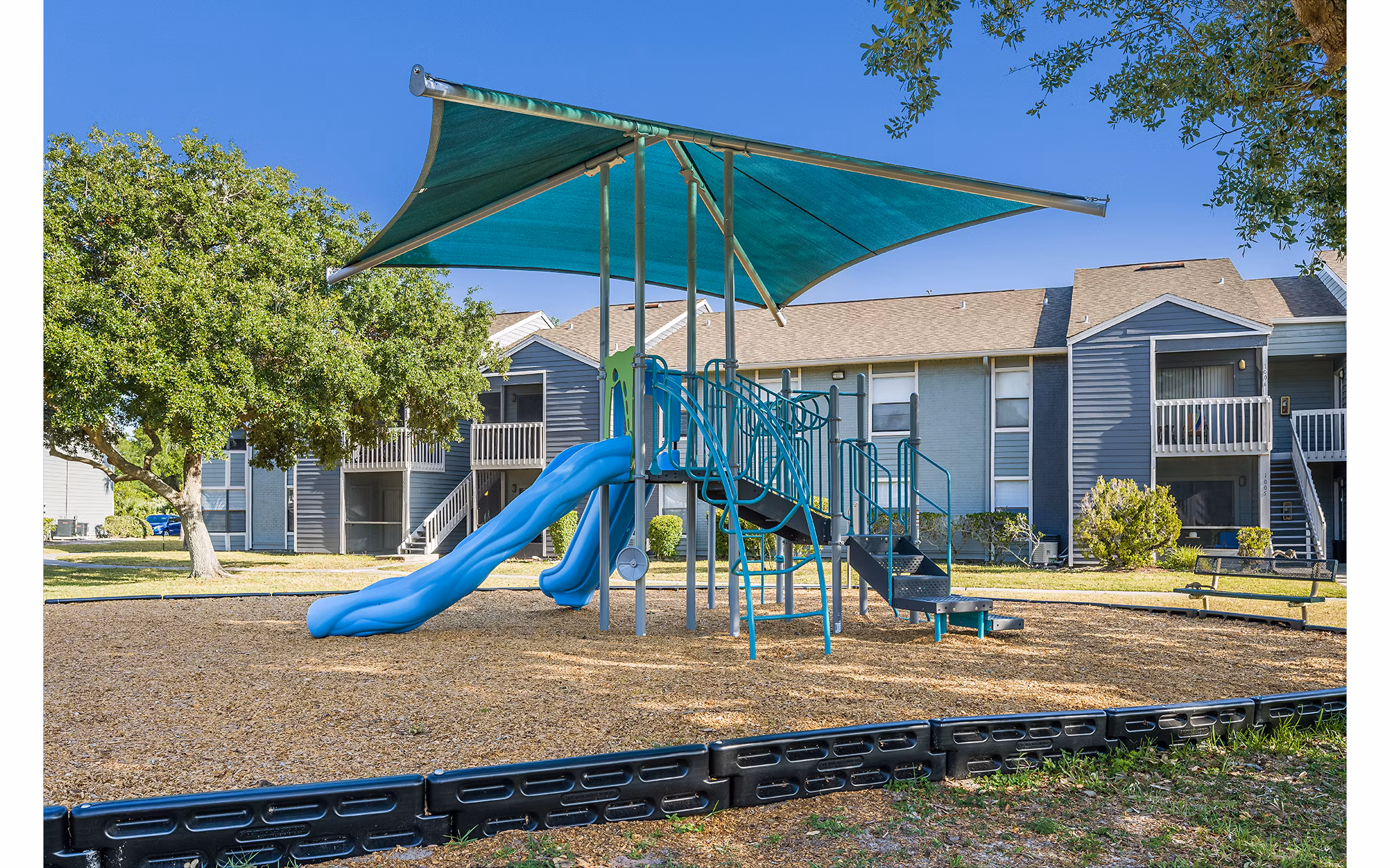 Children's playground with colorful equipment at Lake Pointe Apartments
