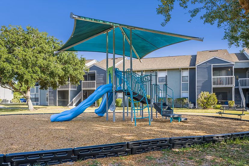 Children's playground with colorful equipment at Lake Pointe Apartments