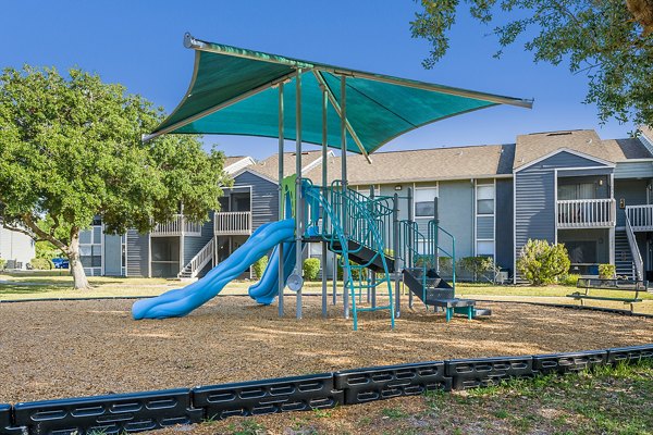 Children's playground with colorful equipment at Lake Pointe Apartments