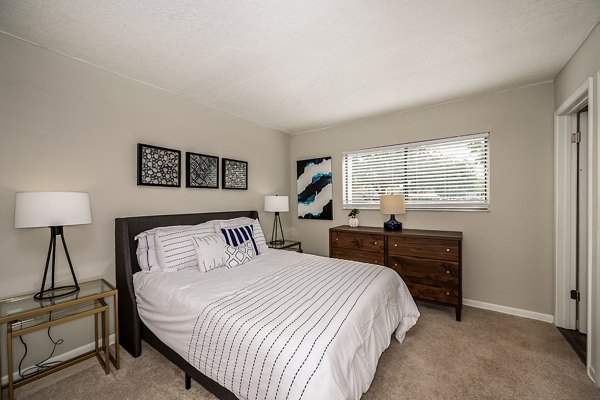 Cozy bedroom with chic decor at The Vinyards Apartments