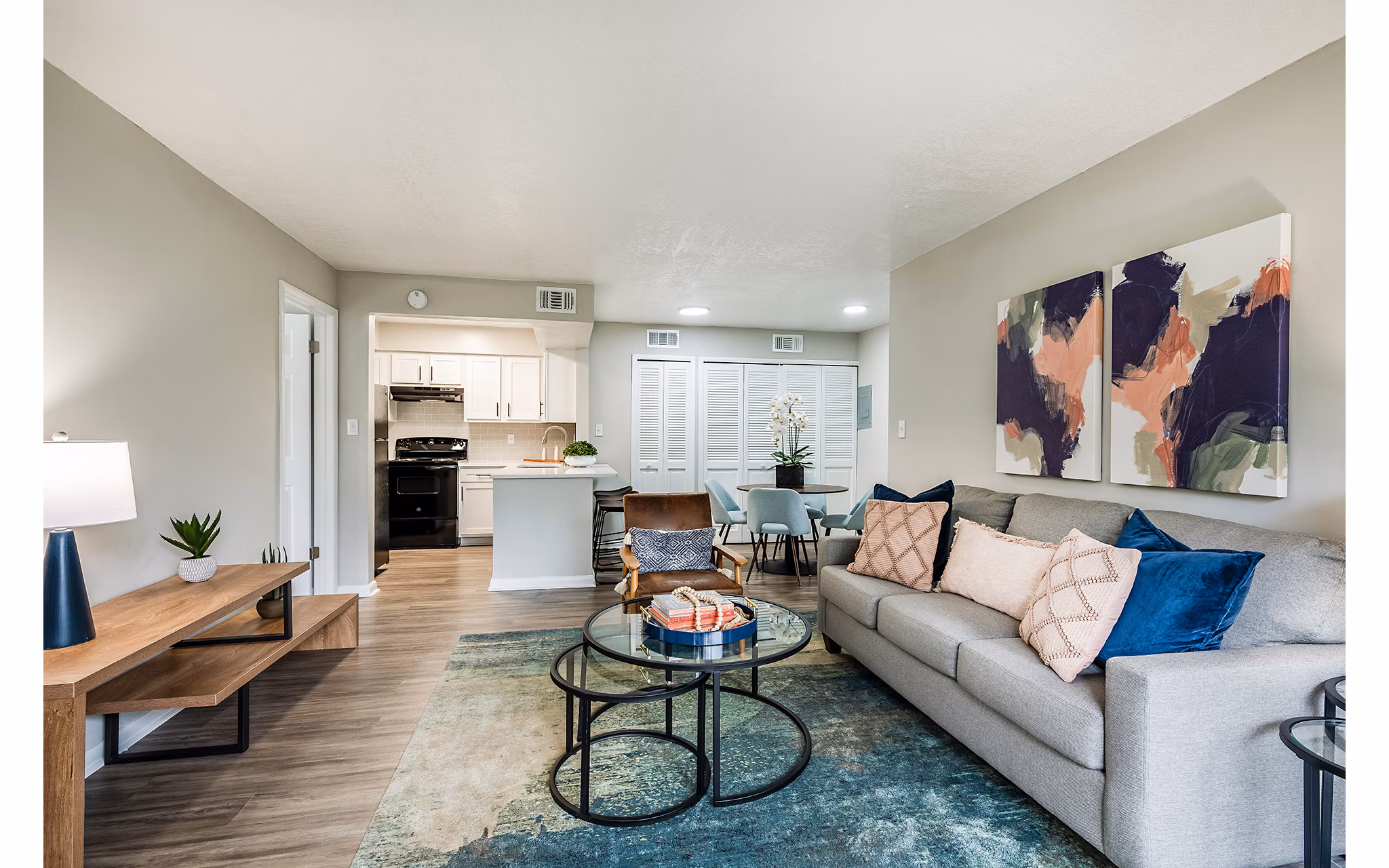 Spacious living room with stylish decor and large windows in The Vinyards Apartments