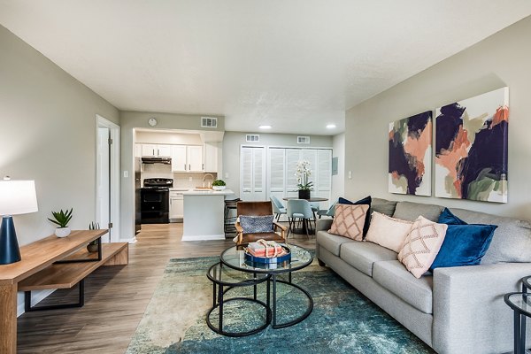 Spacious living room with stylish decor and large windows in The Vinyards Apartments