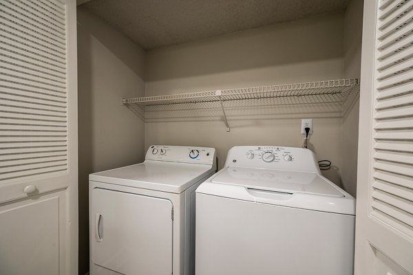 Laundry room featuring state-of-the-art washers and dryers at The Vinyards Apartments