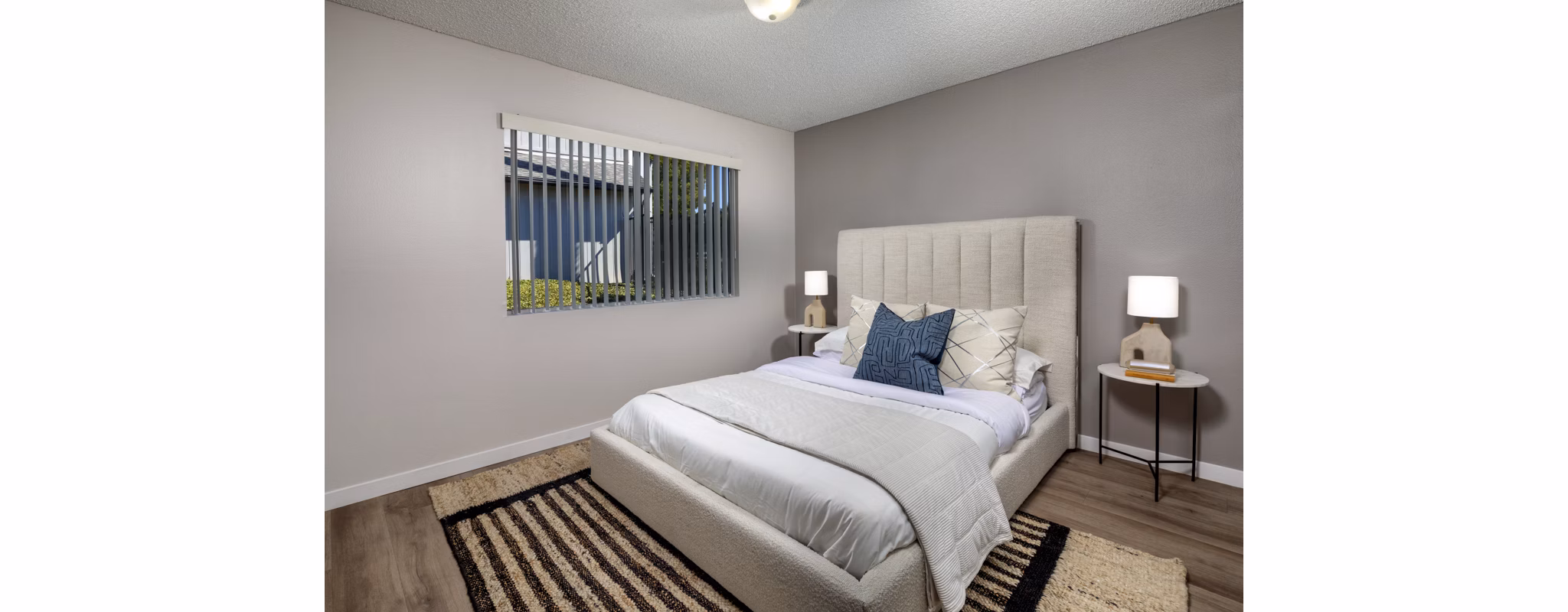 Bedroom featuring modern furnishings and natural light at Windscape Village Apartments in this Greystar community image