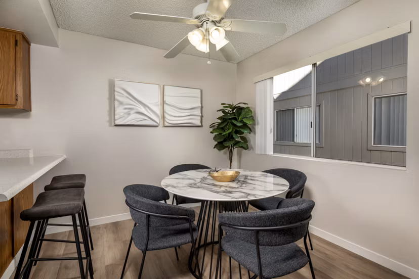 Dining area with modern furnishings and elegant lighting at Windscape Village Apartments