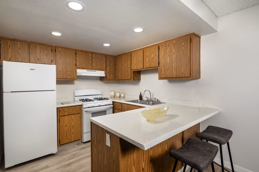 Kitchen with modern appliances and sleek countertops at Windscape Village Apartments