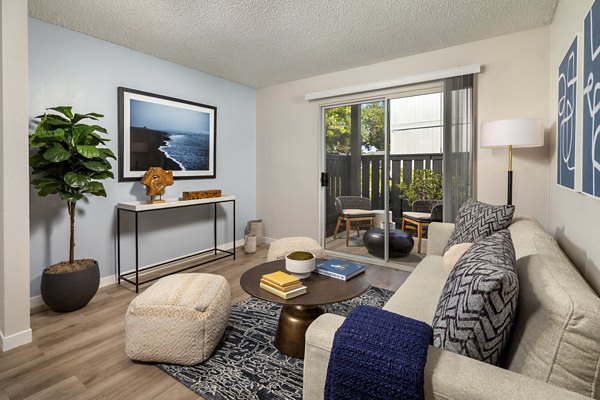 Entry and living room with modern decor at Windscape Village Apartments, a luxury apartment community