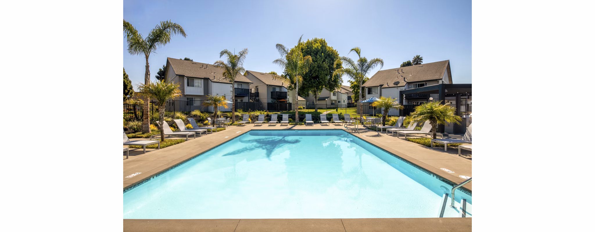 Relaxing jacuzzi at Windscape Village Apartments with sunny poolside seating