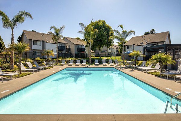 Relaxing jacuzzi at Windscape Village Apartments with sunny poolside seating
