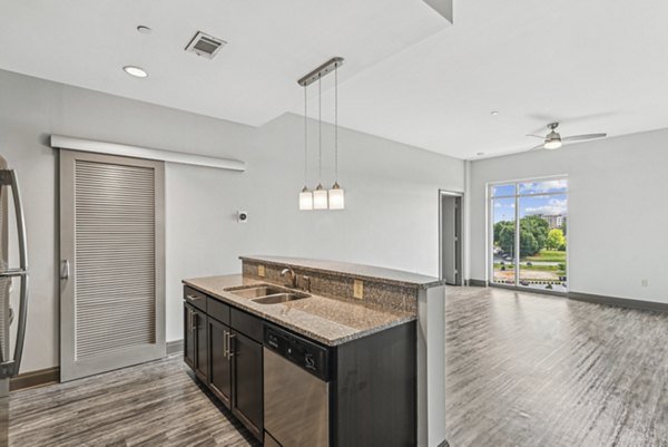 Modern kitchen featuring stainless steel appliances at Rivers Edge Apartments, offering luxury living at its finest