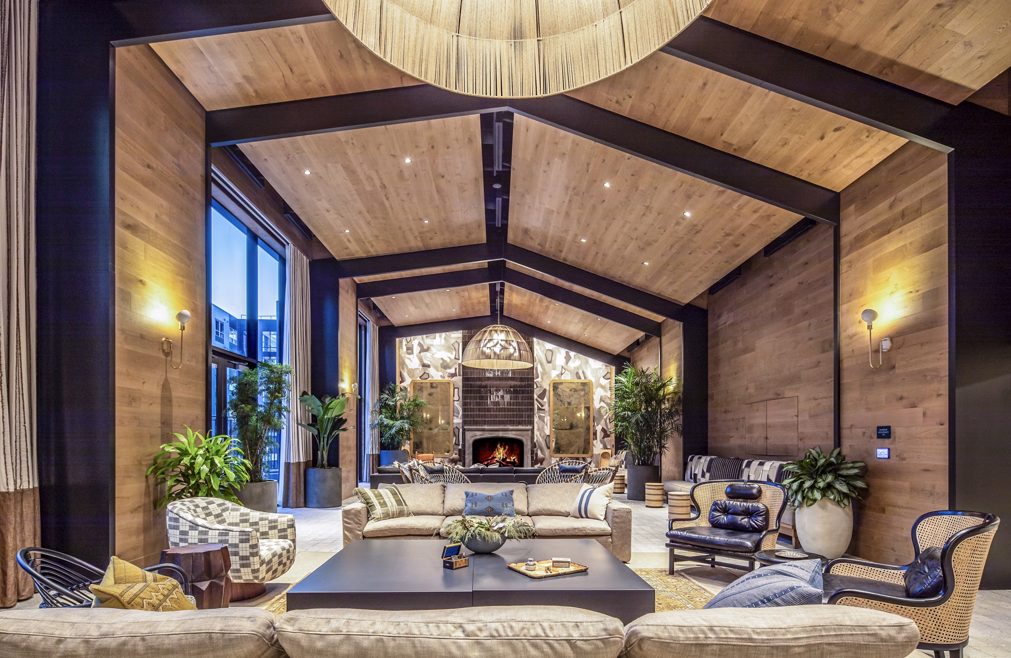 The Lucie Apartments: Spacious living room with a wooden ceiling, modern furniture, and fireplace