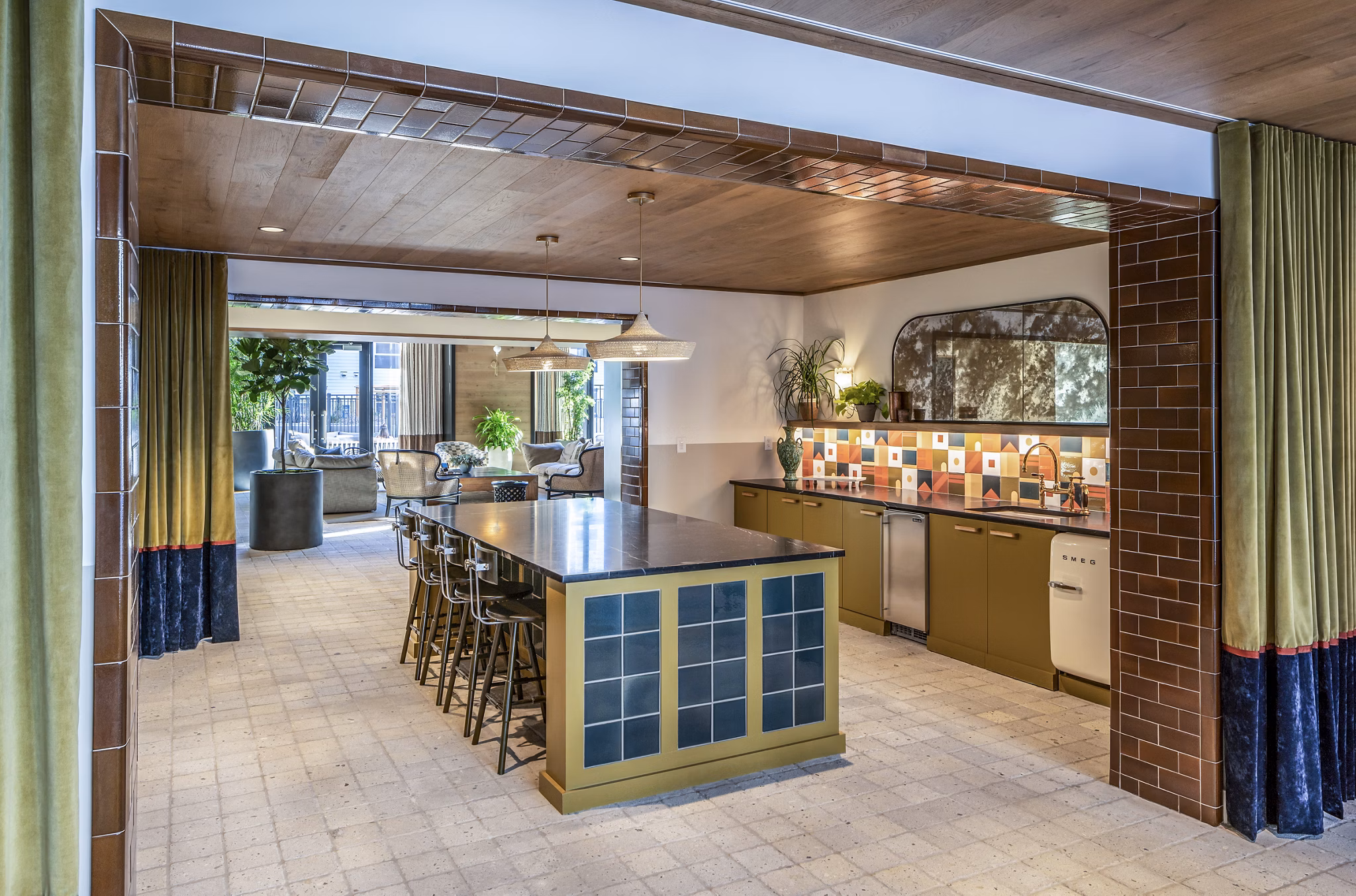 Spacious kitchen featuring an island, colorful backsplash, and dining area in The Lucie Apartments