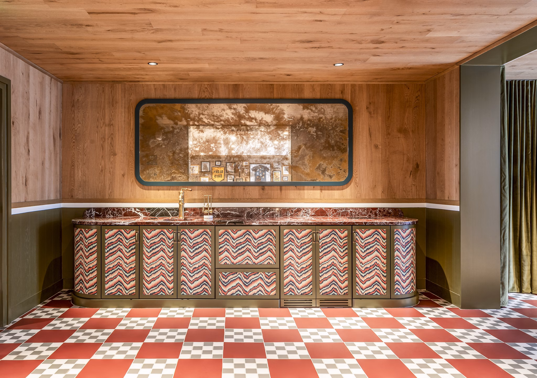 Retro-style kitchen featuring patterned cabinets and checkered floor tiles at The Lucie Apartments