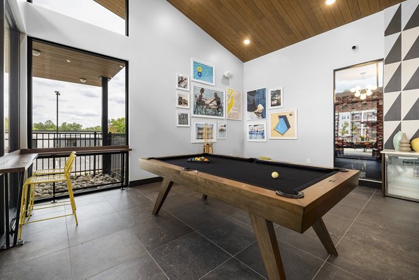 Game room with pool table and seating at Broadstone Oak City Apartments