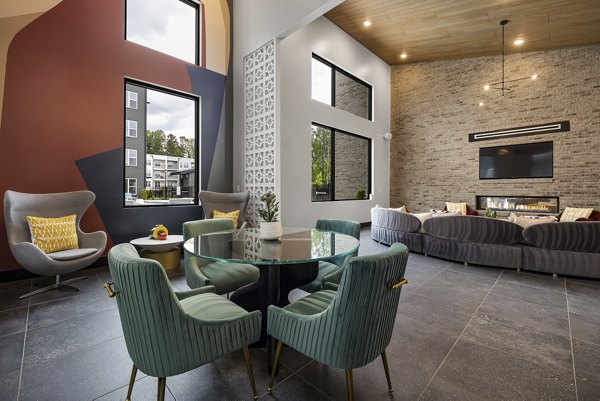 Clubhouse at Broadstone Oak City Apartments featuring modern decor and recreational amenities for residents in a luxury setting