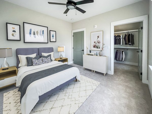 Cozy bedroom with modern furnishings at Novel Cary Apartments, a luxury Greystar community