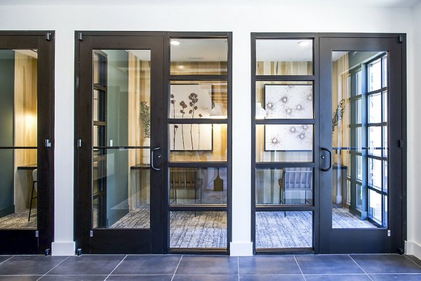 Clubhouse with communal work area at Novel Cary Apartments featuring modern decor and collaborative spaces