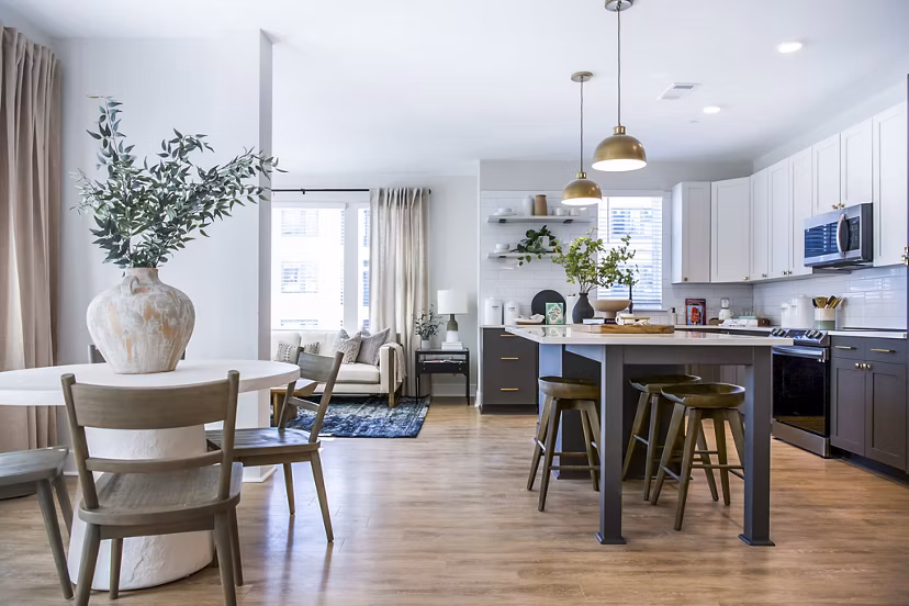 Dining room with elegant lighting and modern furnishings at Novel Cary Apartments in North Carolina