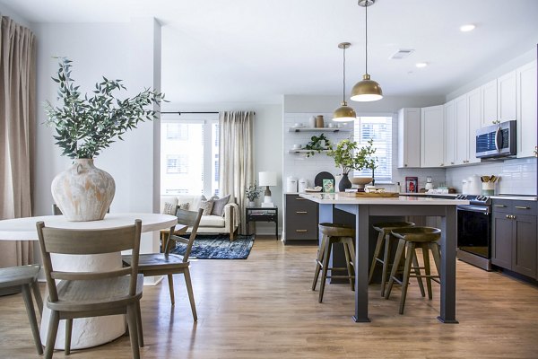 Dining room with elegant lighting and modern furnishings at Novel Cary Apartments in North Carolina