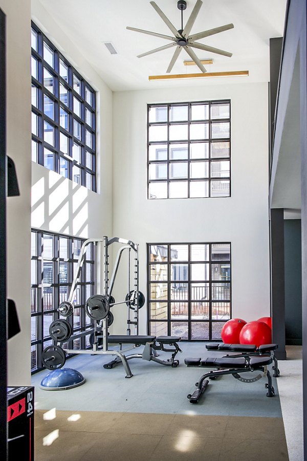 Modern fitness center with state-of-the-art equipment at Novel Cary Apartments, offering luxury living and wellness amenities for residents