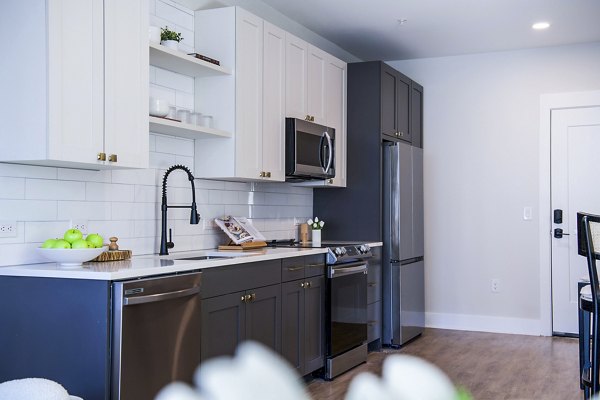 Modern kitchen with stainless steel appliances in Novel Cary Apartments