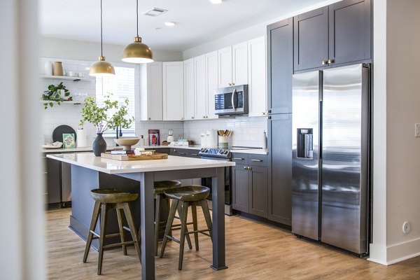 Modern kitchen with upscale finishes at Novel Cary Apartments: Luxury living spaces in a premier community near dining and shopping options