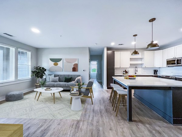 Elegant living room with contemporary decor at Novel Cary Apartments, featuring stylish furnishings and ample natural light