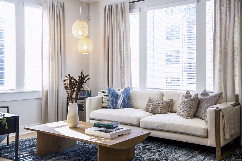 Modern living room with sleek furniture and natural lighting at Novel Cary Apartments