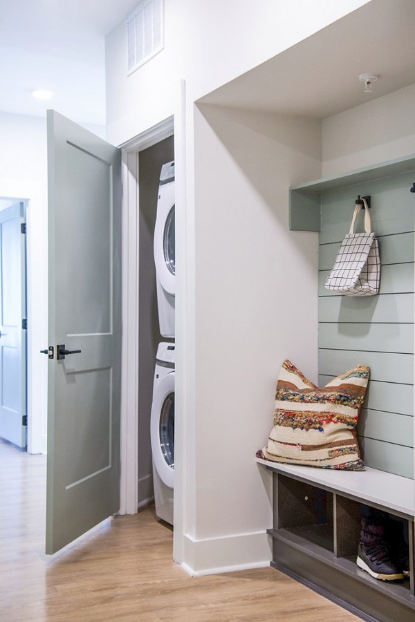 Laundry room with modern appliances at Novel Cary Apartments, offering convenience and efficiency in luxury apartment living