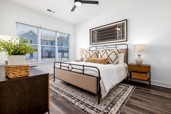 Cozy bedroom with modern decor at The Pace at Holding Village Apartments