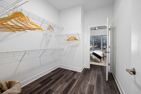 Walk-in closet with custom shelving in The Pace at Holding Village Apartments