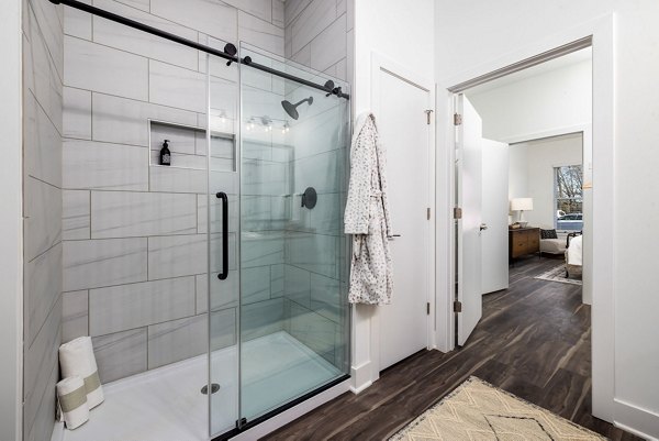 Modern bathroom with dual sinks and stylish fixtures at The Pace at Holding Village Apartments
