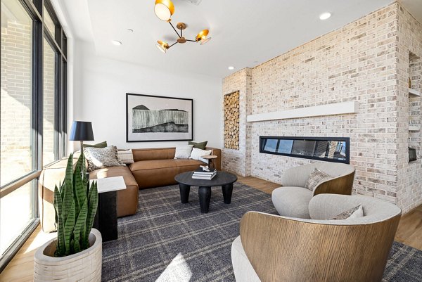 Clubhouse with modern decor and ample seating at The Pace at Holding Village Apartments