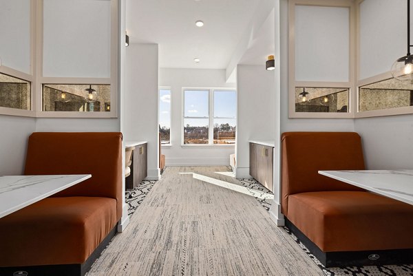 Clubhouse with modern design and community seating at The Pace at Holding Village Apartments Perfect for social gatherings and relaxation