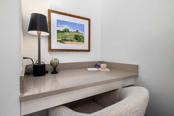 The Pace at Holding Village Apartments: Stylish home office with built-in desk and ample natural light