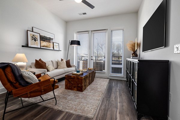 Open layout living room with modern decor at The Pace at Holding Village Apartments