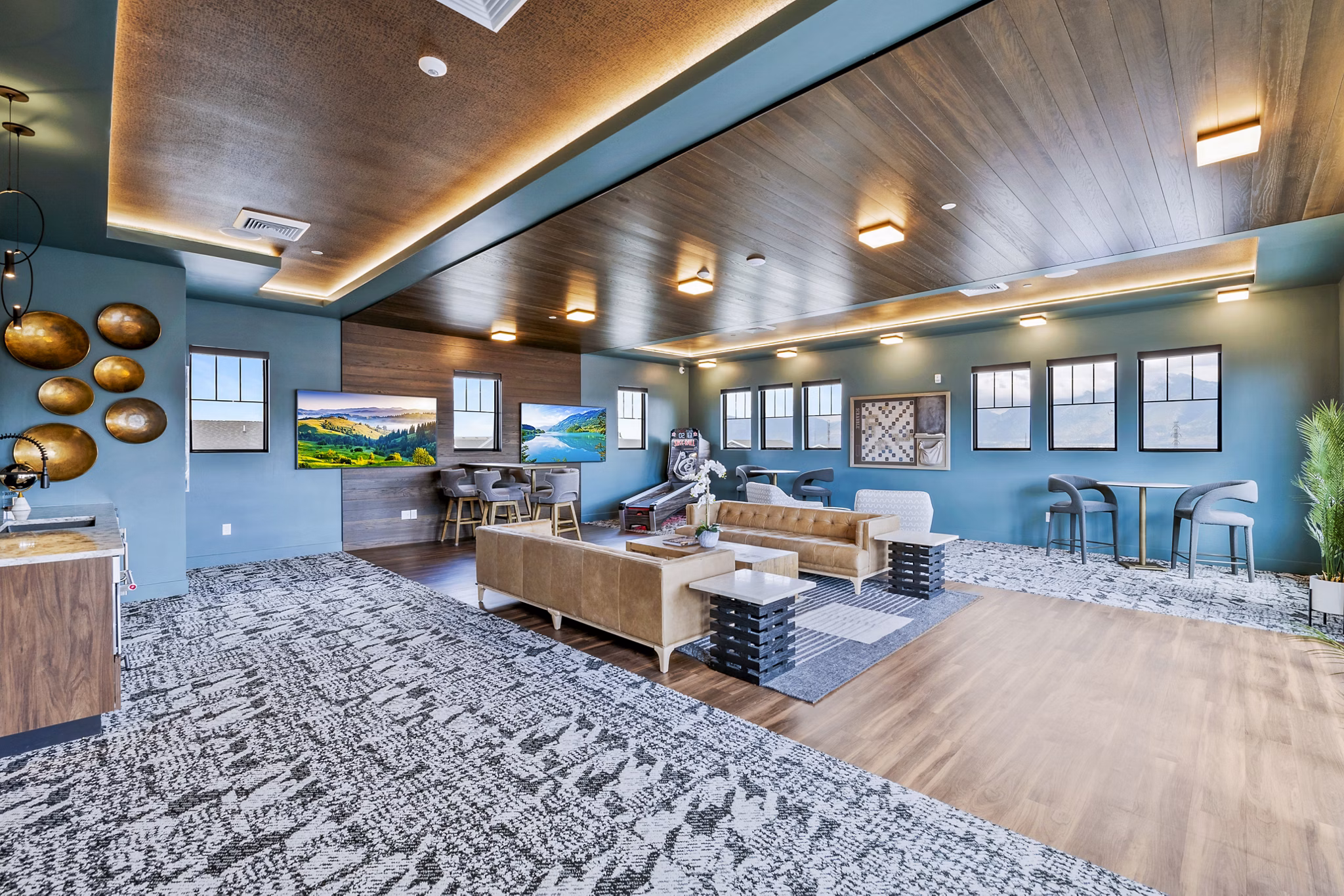 Clubhouse game room with pool table and seating area at Viviano at Riverton Apartments