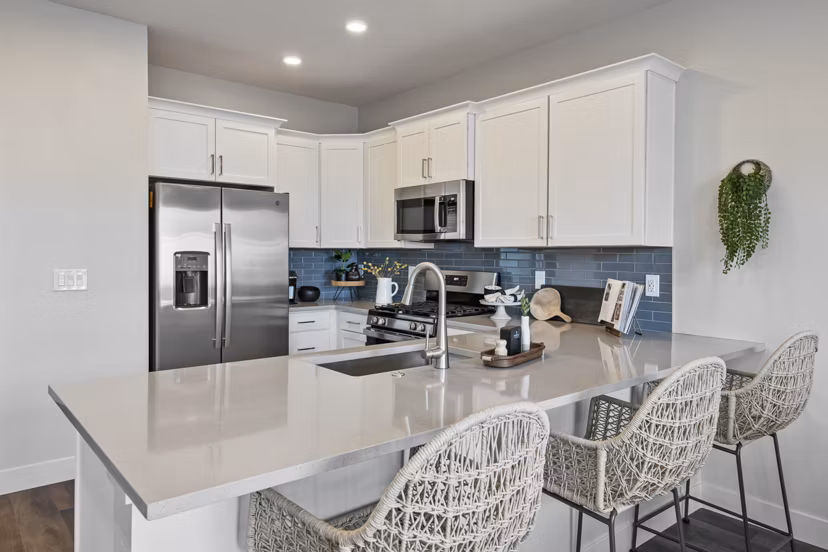 Modern kitchen with sleek countertops and stainless steel appliances at Viviano at Riverton Apartments