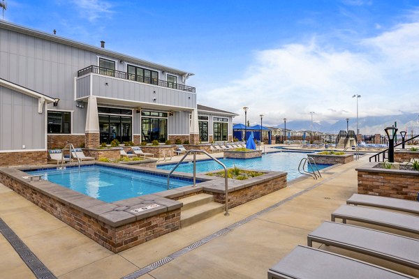 Outdoor pool with sun loungers at Viviano at Riverton Apartments